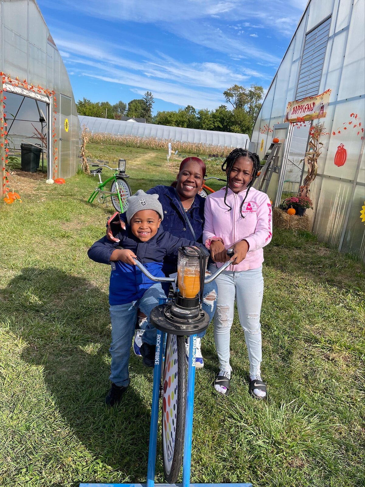DPSCD families make their own pumpkin smoothies on a bike-powered blender at Drew Farms Harvest Fest.