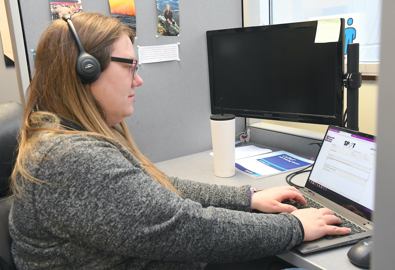 Kelly Quinn, on the phone, is a clinical social worker at Summit Pointe’s First Step Urgent Care.