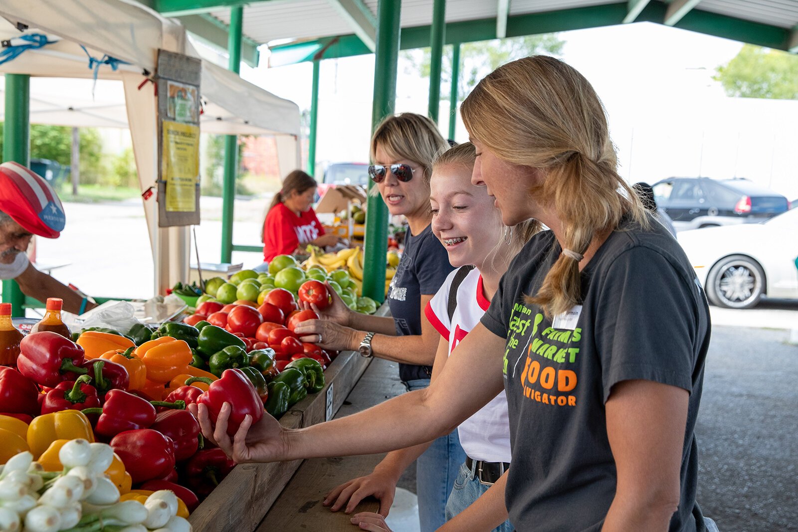 Amy St. Germain talks to visitors at the Muskegon Farmers Market.
