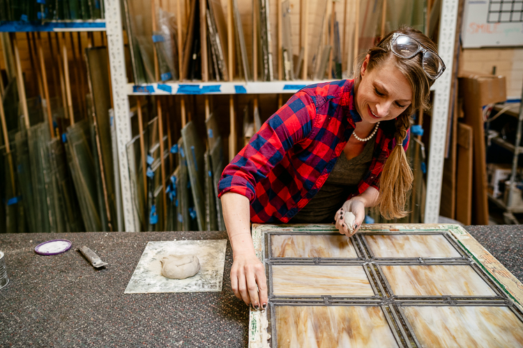 Amy Swift glazes a window.