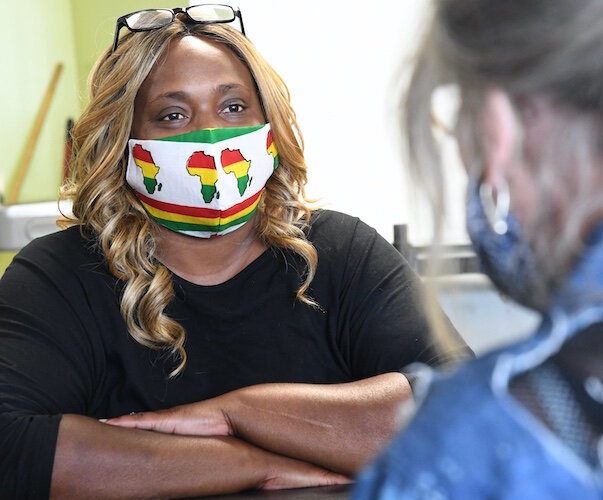 Antwoine Davis, a Health Care Advocate with Summit Pointe, often helps people in Battle Creek and Calhoun County deal with housing issues. Here she meets with a woman, a potential client, at the SHARE Center in Battle Creek.