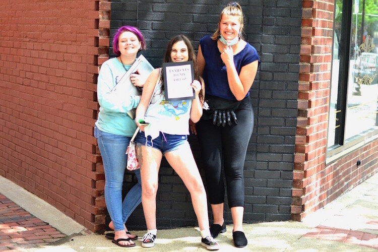 The very first bride to patronize the shop since it reopened said yes to her dress. From left is: Jillian Willoughby, Emily Moyle (the bride) and Rachel Hansen. Hansen was the Memories Bridal shop employee who served as Moyle’s consultant.