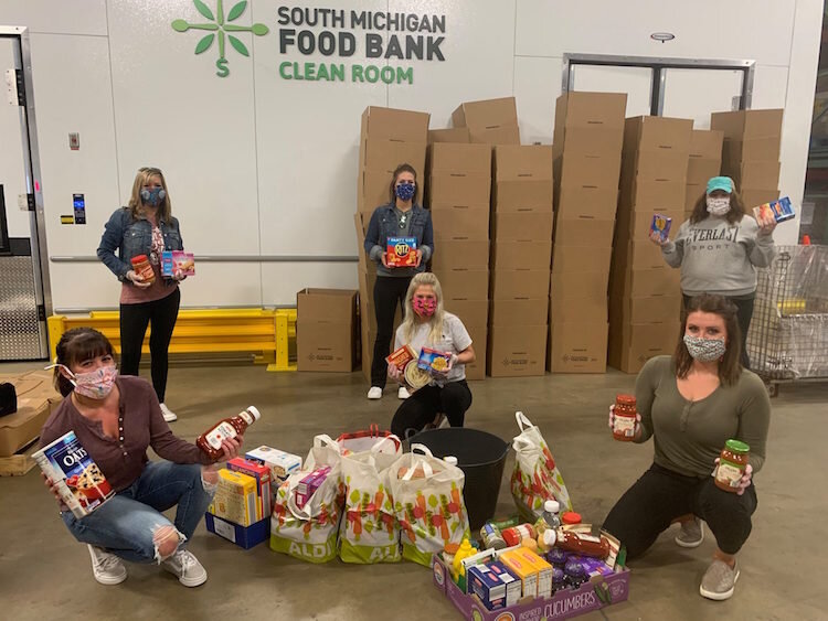 FireKeepers Casino volunteers are among those helping to keep the community healthy and fed by wearing masks, gloves, and social-distancin as they packed food.