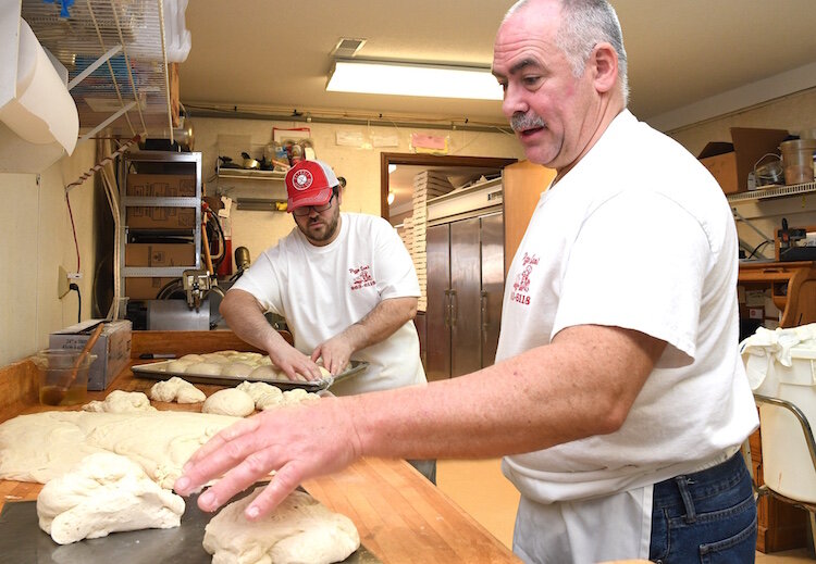 No. 3 Tim Wygant, right, and his son Jordan, prepare pizza dough at Pizza Sam’s.
