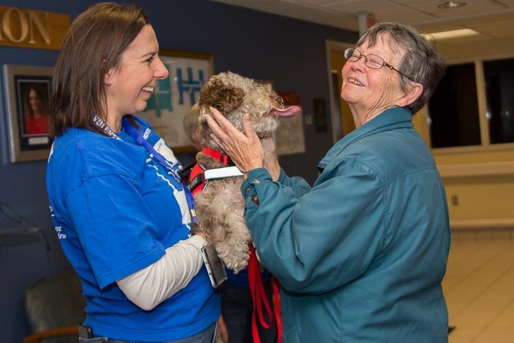 Brittany Gervais’s therapy dog Lucy gives doggy kisses to veterans.