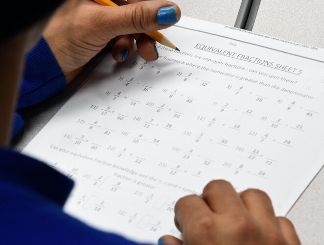 Lilleana Bottom, DENSO employee, works on Math problems as she pursues her GED diploma.