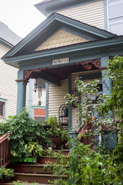 Visitors to Sarah Ruggles Cedar Street home are greeted with a welcoming porch and lots of growing things.