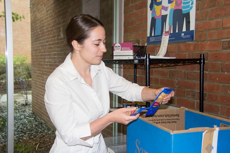 Student worker McKenzie Ryder fills Bruin Baskets. 
