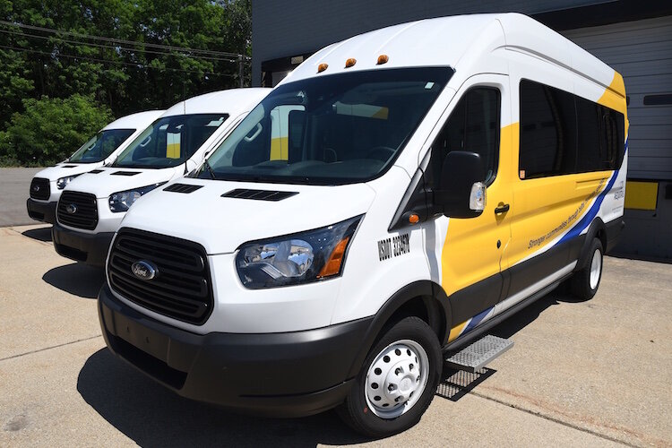 Aequitas Mobility Services’ three vehicles sit outside the organization’s office in Ft. Custer Industrial Park. They serve those who do not have transportation.