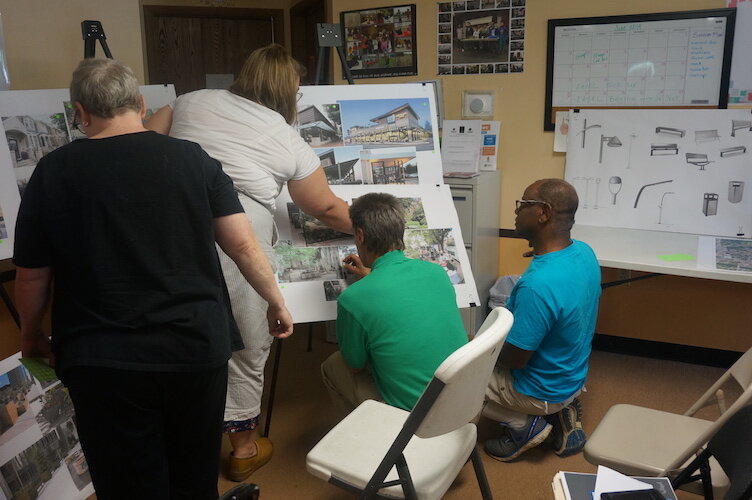 Neighbors study the ideas proposed for for the 1600 block of East Main Street.