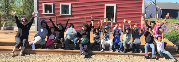 CHAMPS youth enjoy a moment of rest after bicycling with Open Roads on the Kalamazoo Valley River Trail.