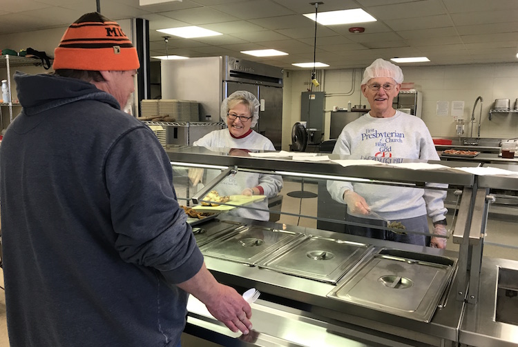 Dinner is served at the Salvation Army in Battle Creek.