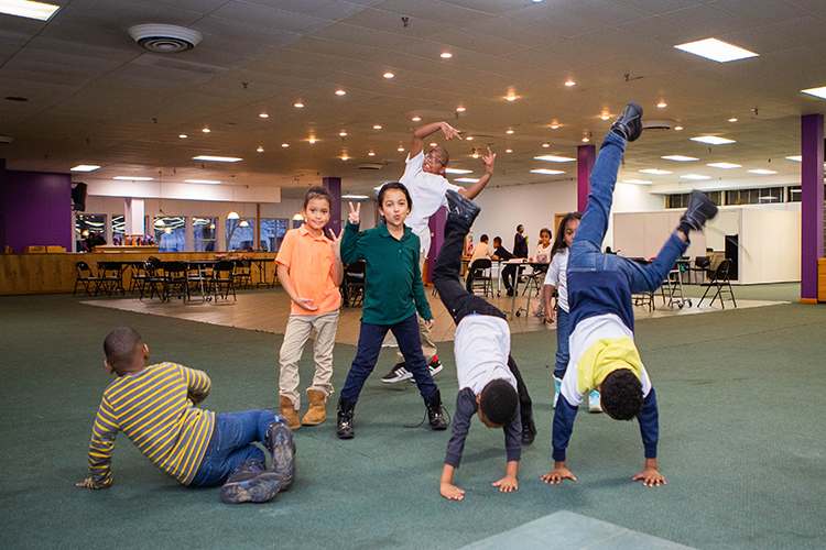 Students eat snacks, work on homework worksheets provided by the organization, and participate in activities such as a robotics workshop.