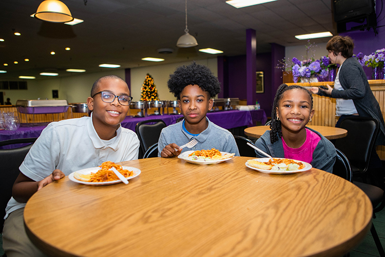 Students eat snacks, work on homework worksheets provided by the organization, and participate in activities such as a robotics workshop.