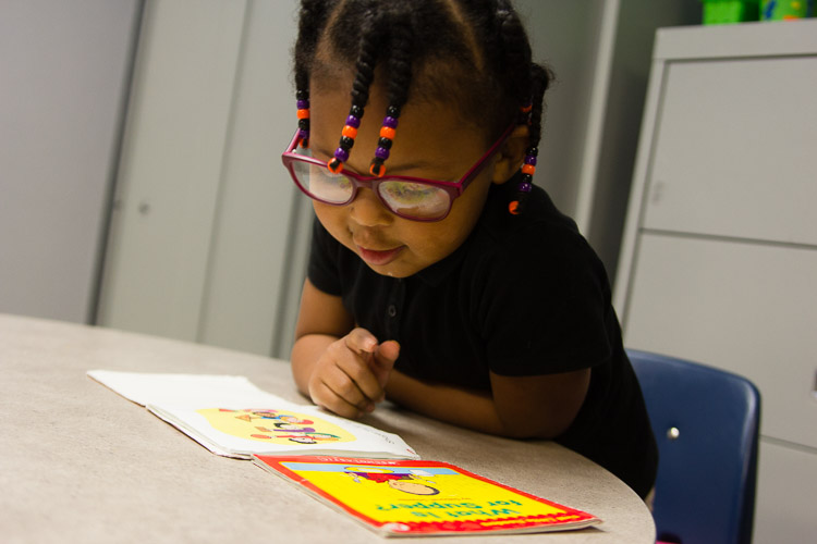 Youngsters enjoy their books at the New Genesis after-school program.