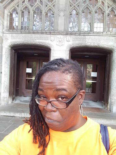 Takisha Booth-Johnson, executive director of Young Kings and Queens in front of law library at the University of Michigan on a college tour with young people this summer.