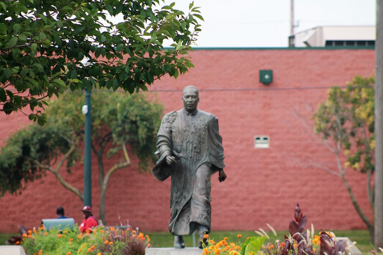 The young women in Kalamazoo Junior Girls learn service through activities such as maintaining the flowers at Dr. Martin Luther King Jr. Memorial Park. Photo by Dontae Travier