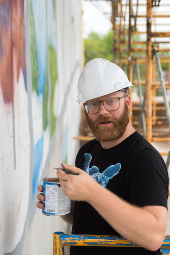 Patrick Hershberger at work on a new mural for the Edison neighborhood. Photo by Fran Dwight