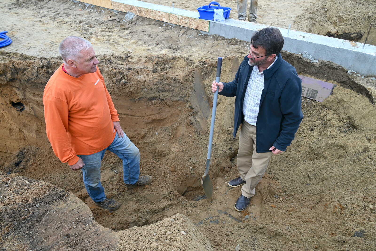Russ Baker of R.A. Baker Plumbing, left, talks with Battle Creek Area Habitat for Humanity’s executive director Mike King on a construction site.