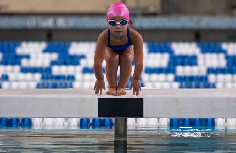 A swimmer competes in the Hartford Nationals.