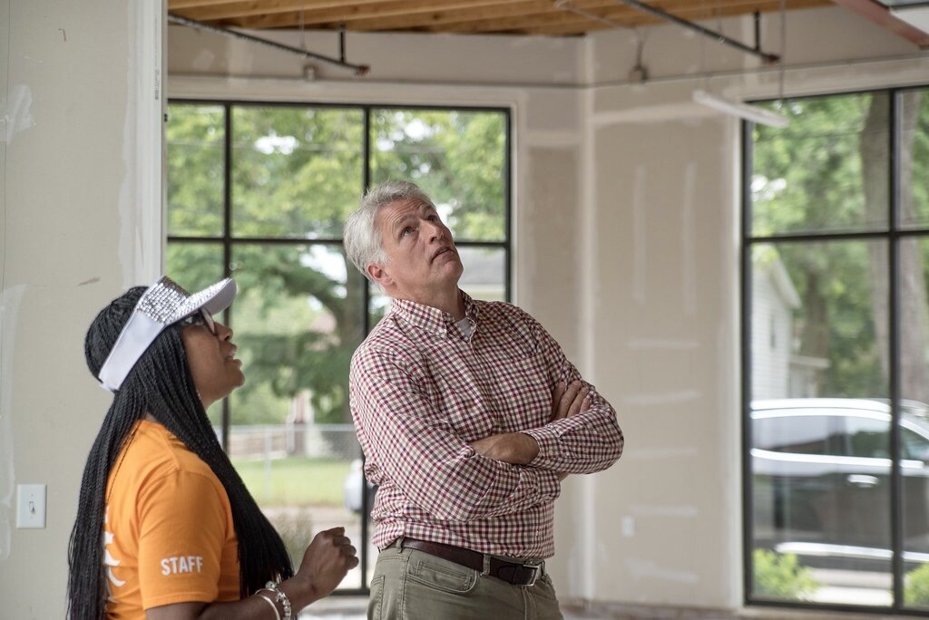 Rob Peterson, of Dover Birch & Associates, talks with visitors about the commercial space inside the new Eastside Square Condominiums.