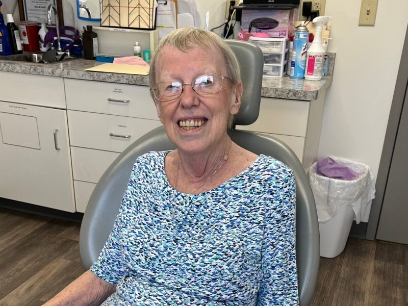 Judy Logan sitting in dental chair at an appointment.