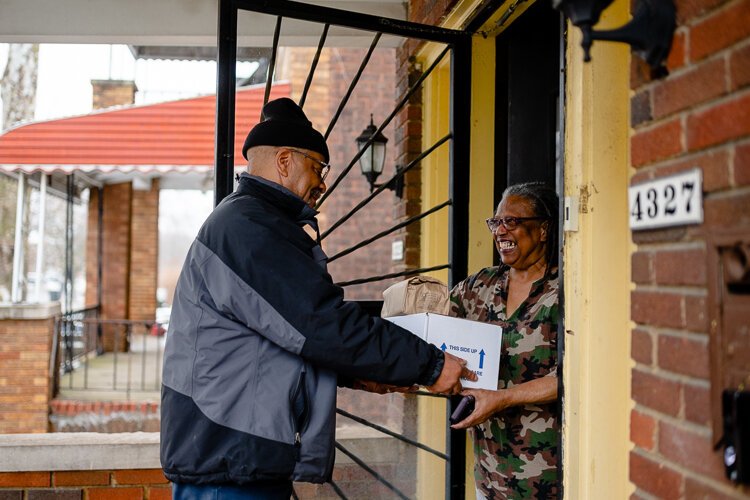 DAAA Meals on Wheels driver Lamar Ellington gives Beverly Sullivan, 79, a meal for her mom, Ellen Dennis, 97.