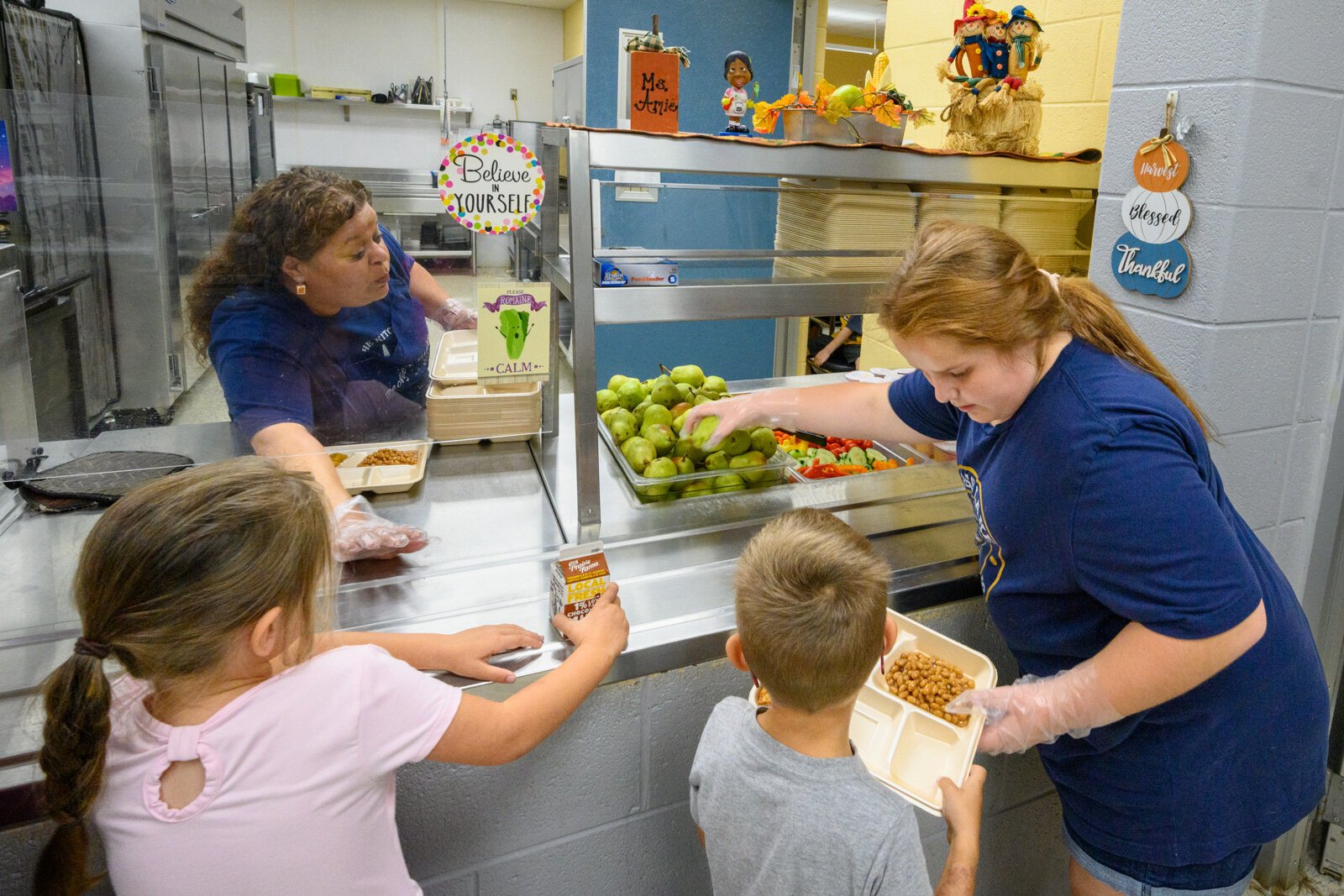 A student at Grass Lake's George Long Elementary School gets a Michigan pear for lunch.