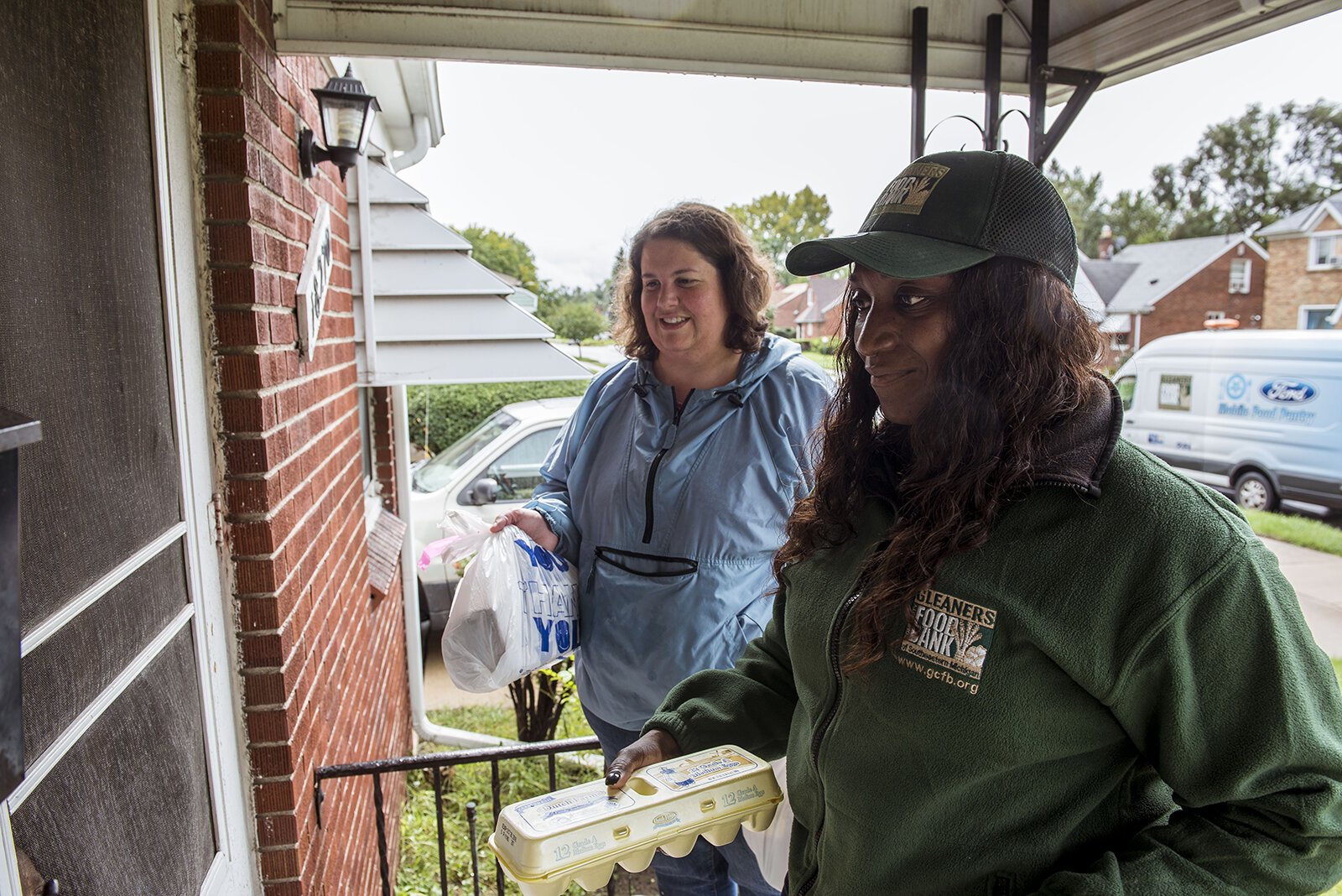 Staff make a delivery of healthy food to a Henry's Groceries participant.