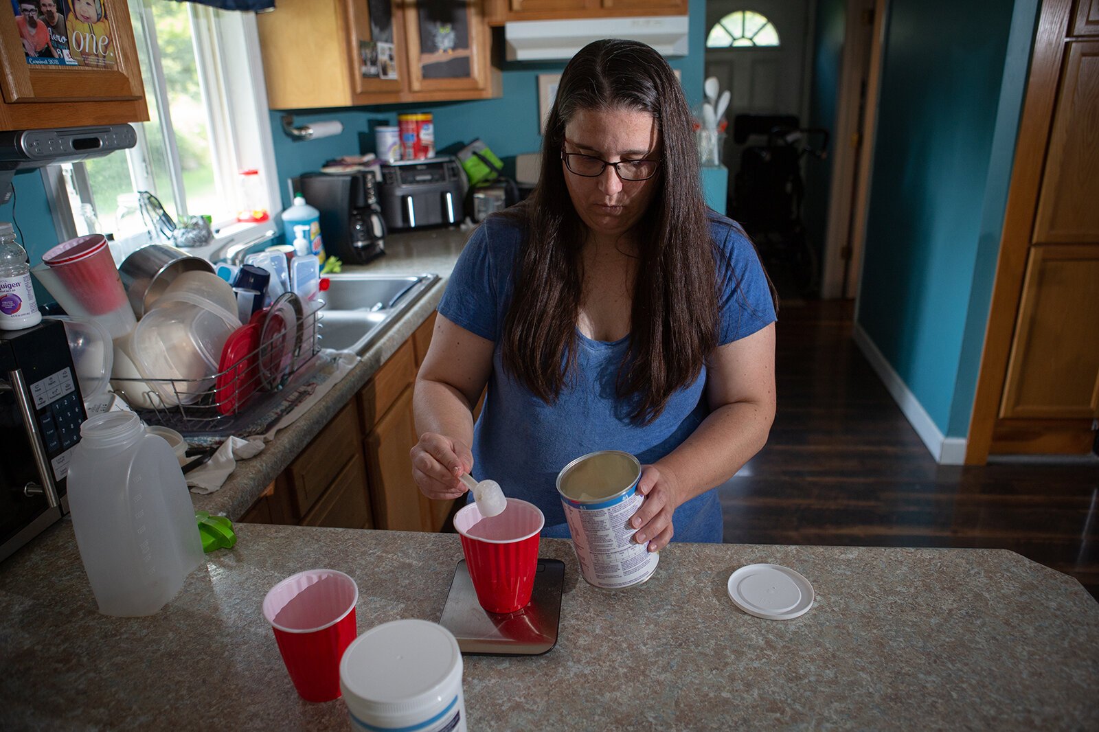 Krista Assman prepares Skyler Assman's food and medications.