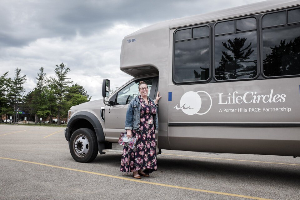 Sarah Milanowski, marketing and communications specialist with LifeCircles PACE, with one of the LifeCircles buses. LifeCircles provides accessible medical transportation to the LifeCircles day center and to other specialty medical providers.