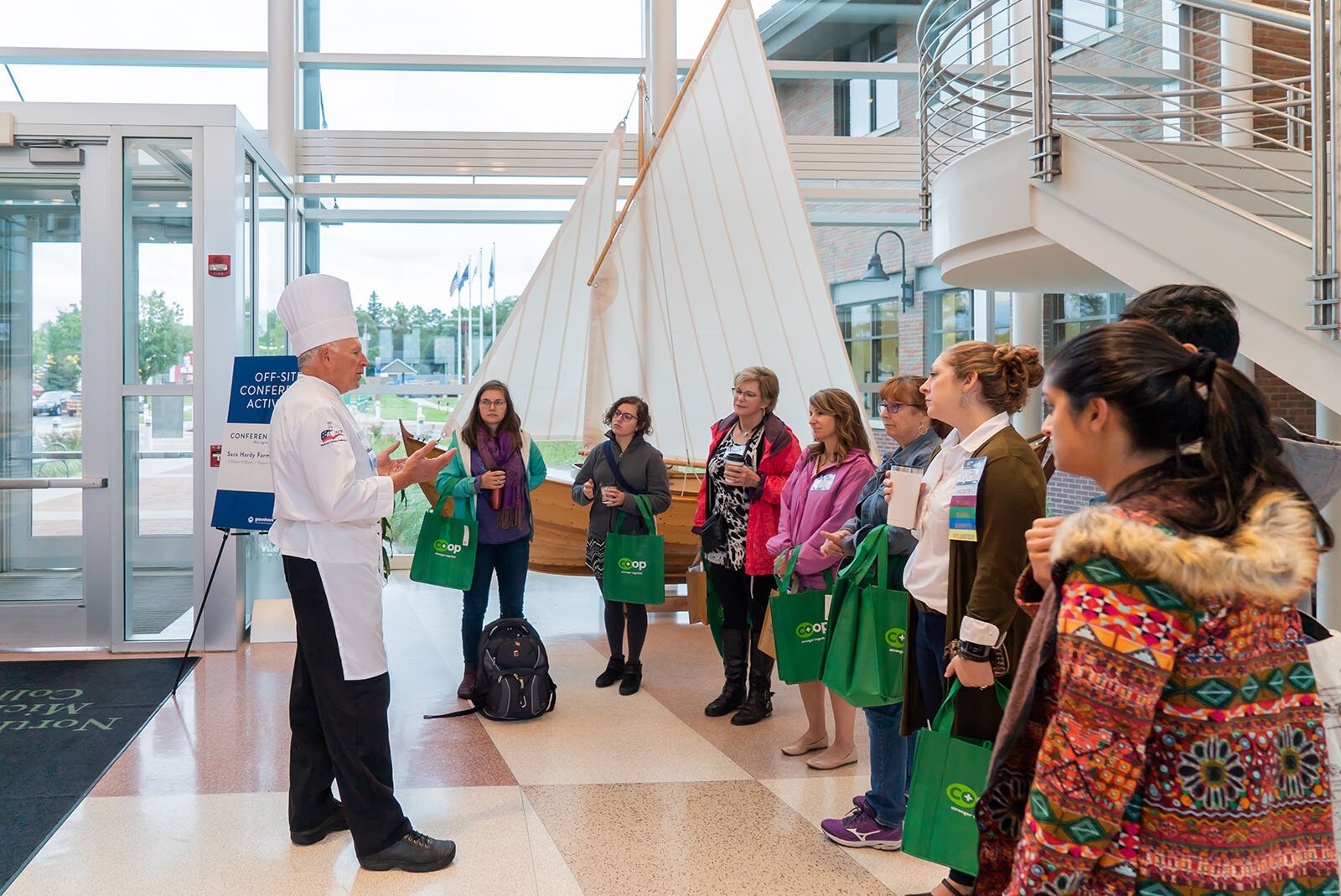 Chef Fred Laughlin prepares to lead a tour of the Sara Hardy Farmers Market in downtown Traverse City with participants in Groundwork Center's 2019 Farms, Food, and Health Conference.