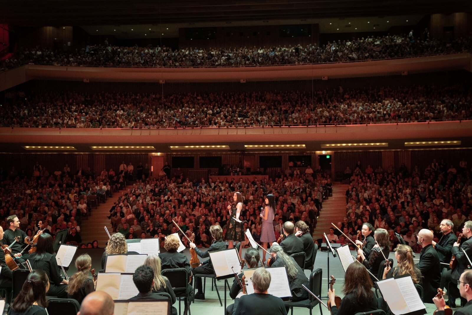 Jessica Mallow Gulley and Lynn Chen-Zhang before a fullhouse at Miller Auditorium in anticipation of Yo-Yo Ma's appearance. Lynn spoke of her first encounter with Yo-Yo Ma's music in line at Starbuck's.