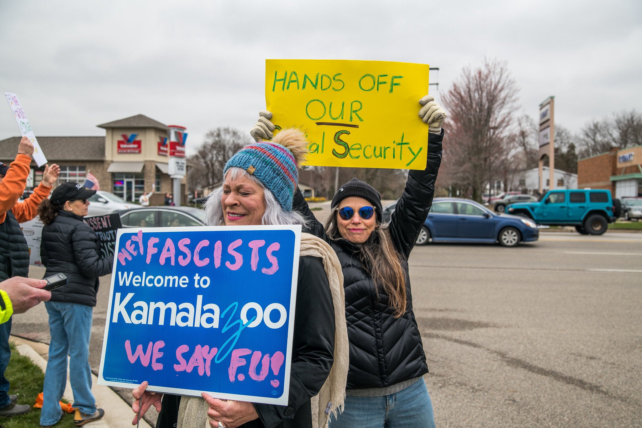 Retired local media personality Lori Moore (blue hat), letting everyone know how she feels. Patti McNulty stands behind her with the yellow sign.