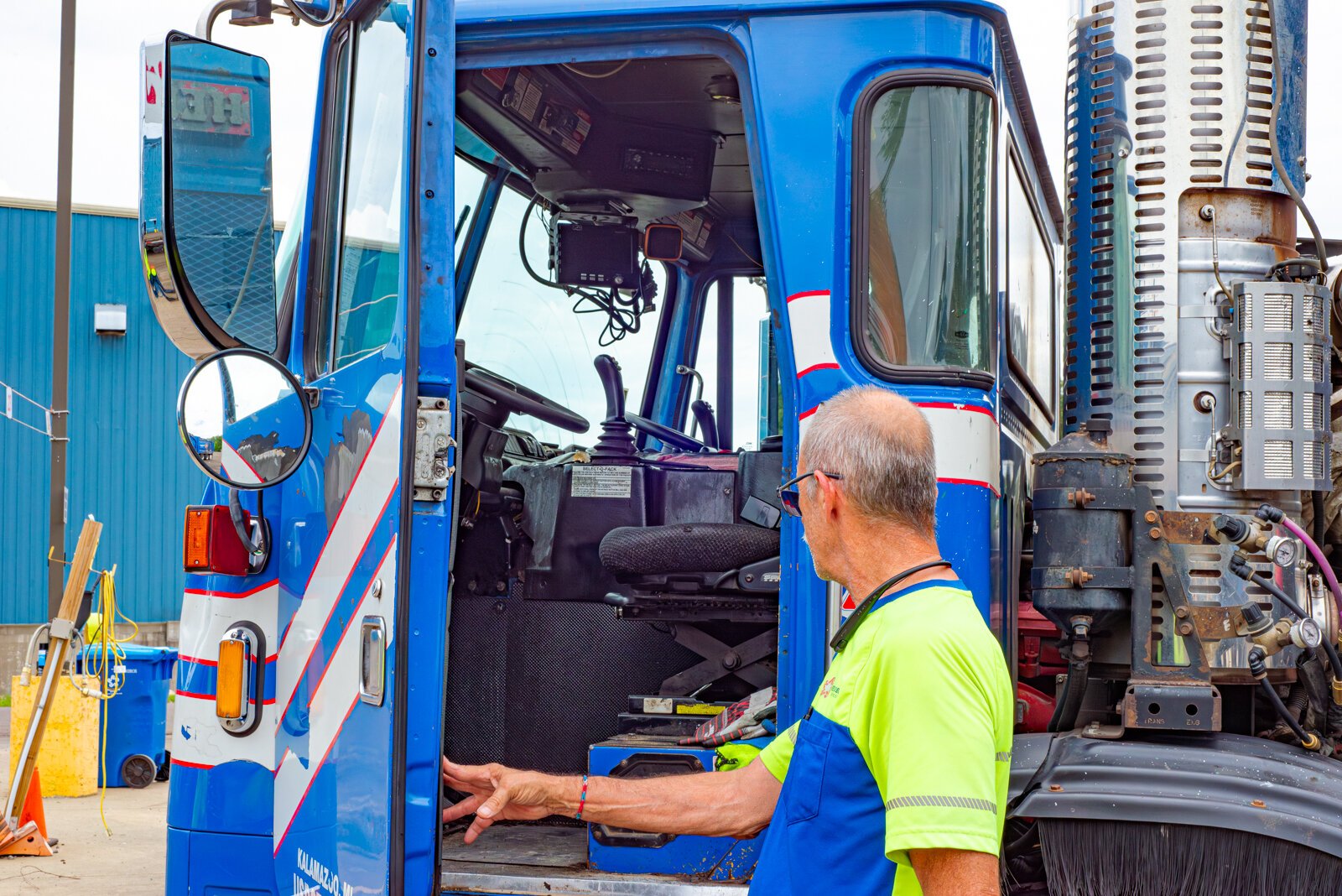 The City of Kalamazoo's sole recycling truck driver, Dale Mentor, opens the cab of his truck.