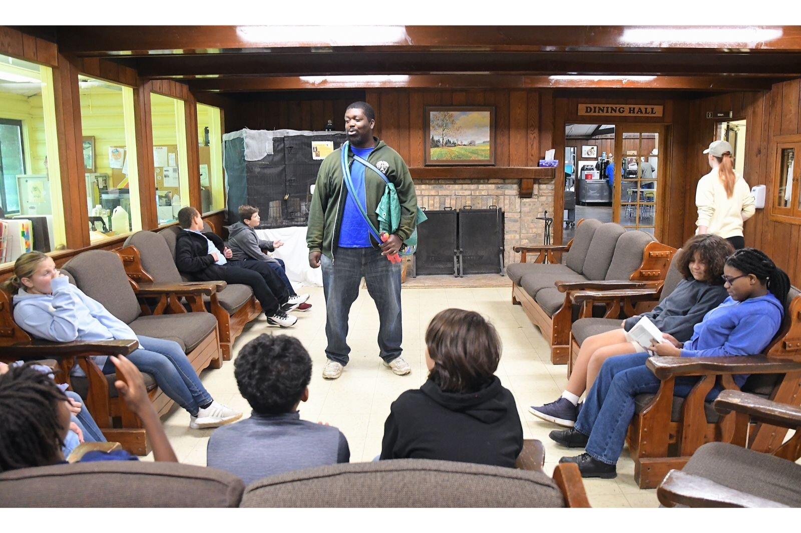 Instructor Jordan Greene talks with STEM students who have just arrived at Clear Lake.