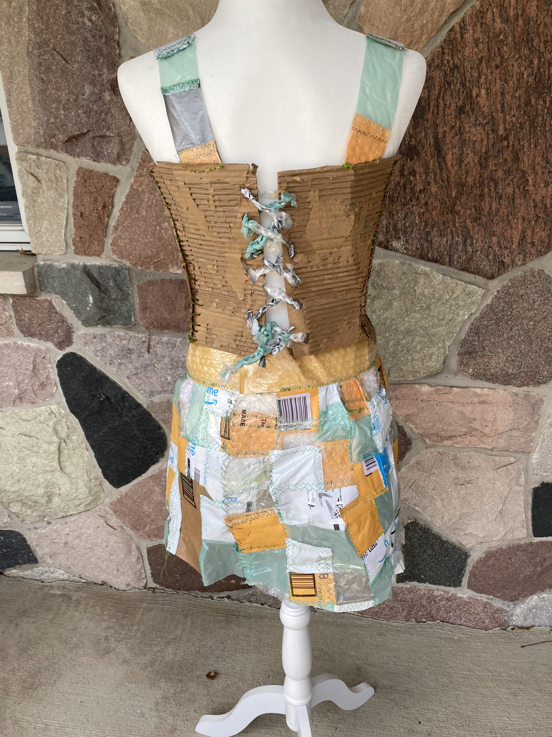 A close-up view of the corset back. The tie for the lace-up was created by making a chain of small strips of plastic using a large crochet hook.