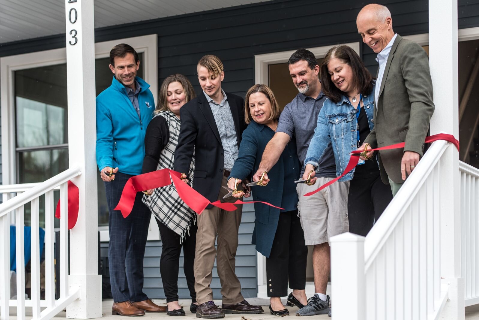 KNHS staff and local officials celebrate a ribbon cutting at 205 Wall St.