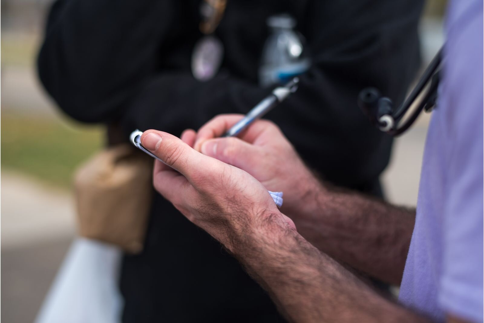 A Street Meds team member takes notes during an examination.