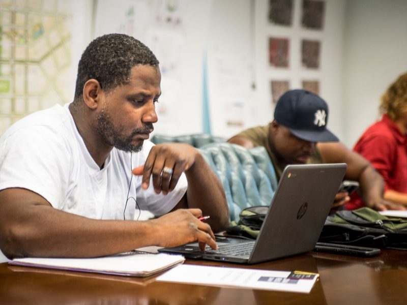 Thaddeaus Bradley studied his laptop and instructional materials during a session of the Core 60 program.