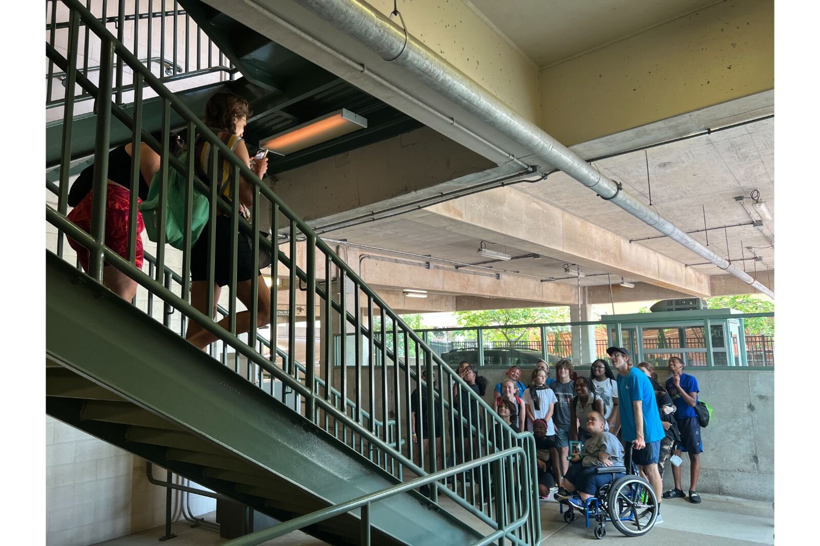 Annalee Roeder and Facilitator Catalina Gonzales snap some photos of their own of the group in a parking structure.