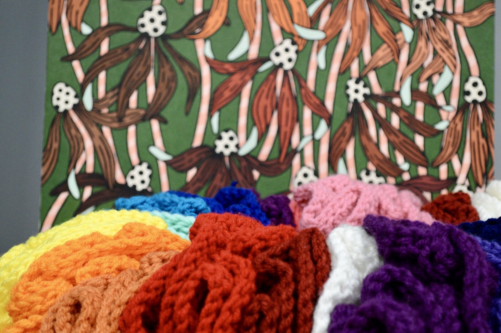 Painting and crocheted flowers by Ellen Nelson.