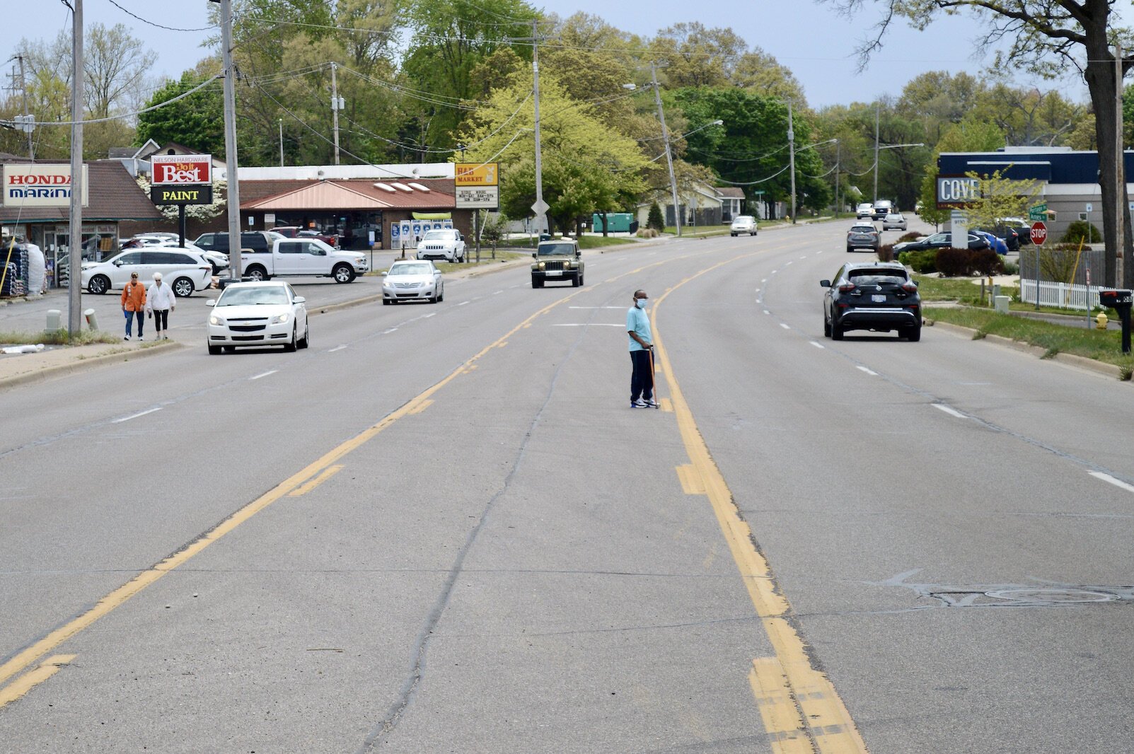 Transportation plans take into account all kinds of needs such as those of pedestrians. A pedestrian attempts to cross Portage Road near West Lake.