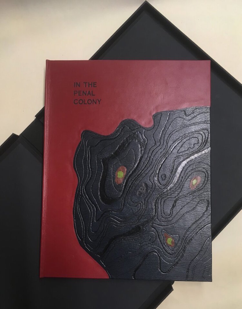 Chad Pastotnik’s books are printed via letterpress on fine papers and are illustrated with artwork from original wood engravings, linocuts, and intaglio prints created directly by visual artists. Deluxe binding of Kafka’s In The Penal Colony.