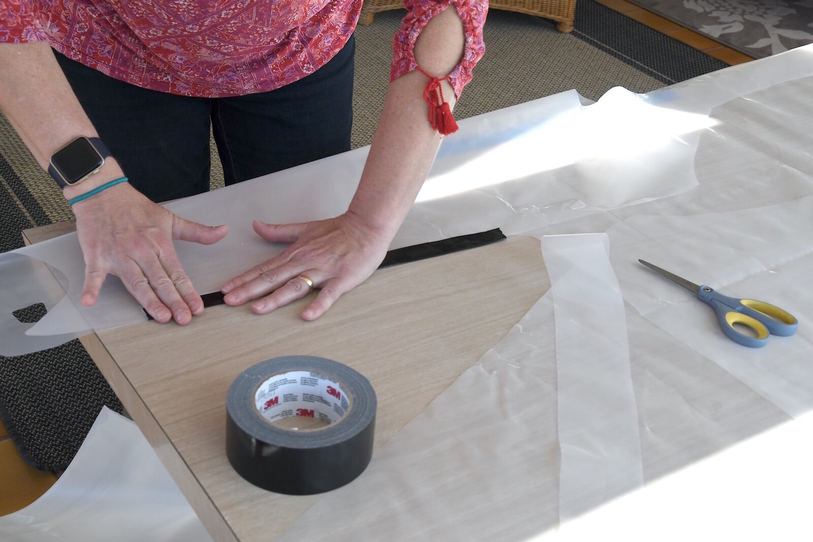 Barb Galonsky uses duct tape for the armpit of an isolation
gown.
