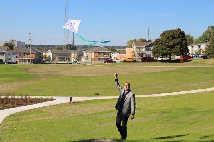 David Marquardt flying a kite at the 2016 reopening of Mary Waters Park following renovations.