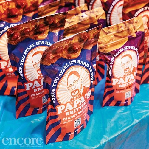 An illustration of the face of Doreen's father, David Smith, adorns Papa's Brittle packaging.