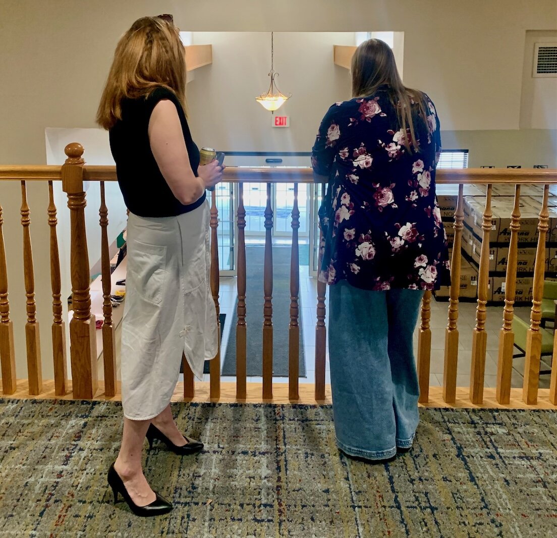 Deputy Housing Director Willa DiTaranto, left, and Kalamazoo County Board Chairwoman Jen Strebs look down at the lobby of the former Country Inn & Suites.
