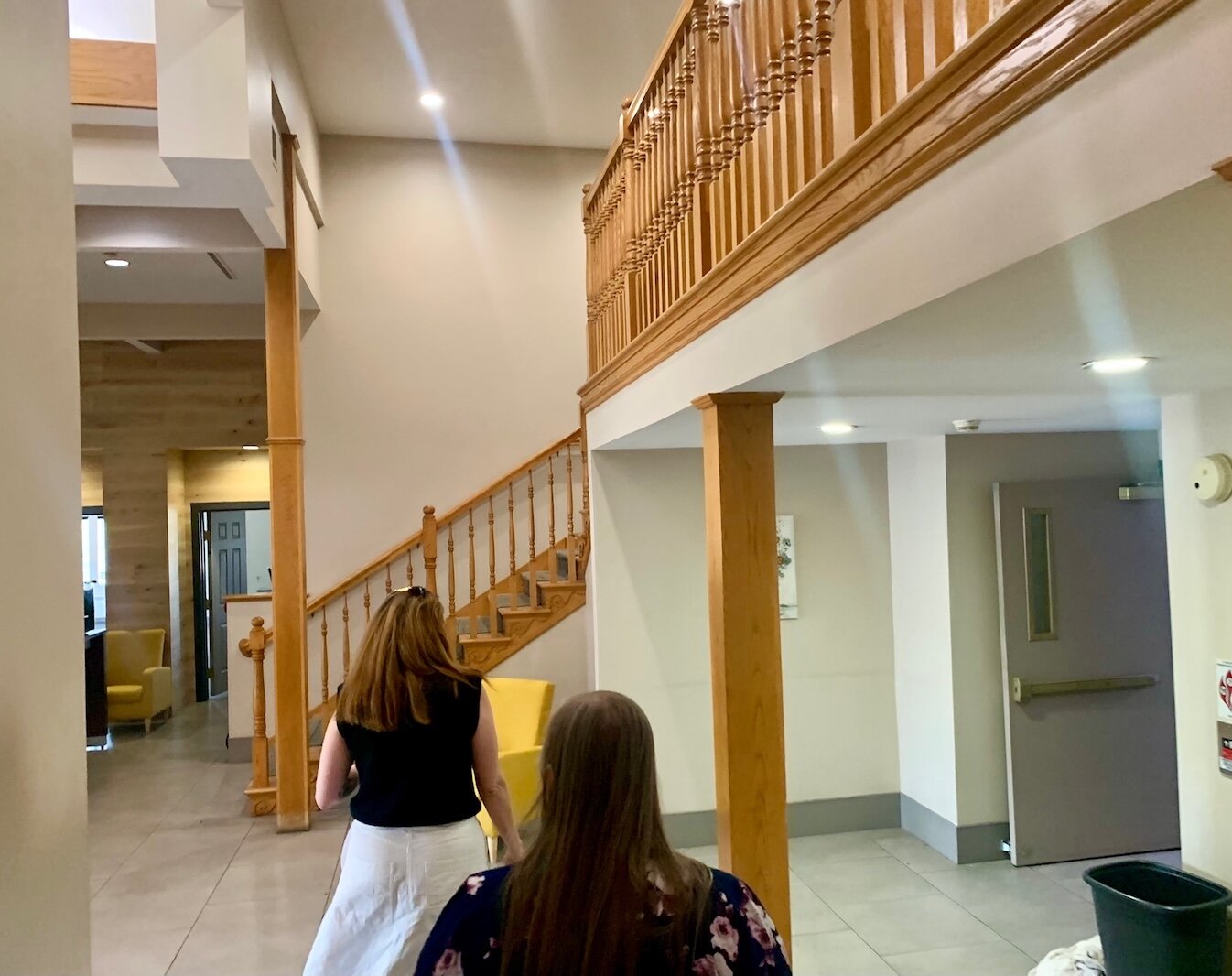 Willa DiTaranto, deputy housing director for Kalamazoo County, and Jen Strebs, chairwoman of the Kalamazoo County Board of Commissioners, tour the lobby of the former Country Inn & Suites.