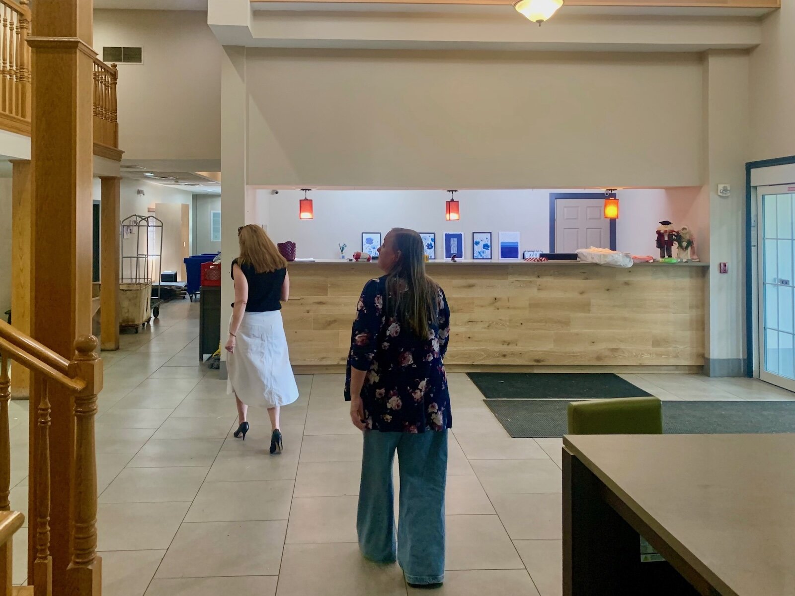 Deputy Housing Director Willa DiTaranto leads Kalamazoo County Board Chairwoman Jen Strebs into the lobby area of the former Country Inn & Suites.